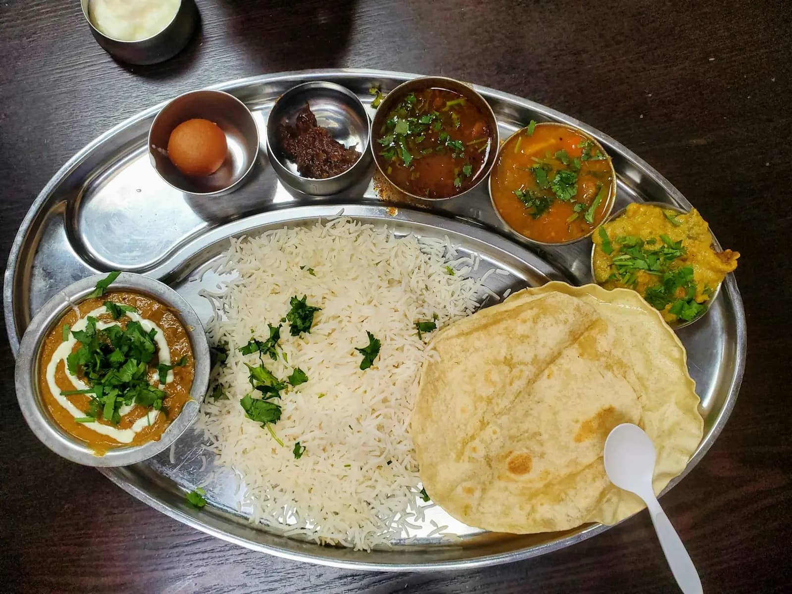 Rice and curries served in brass bowls