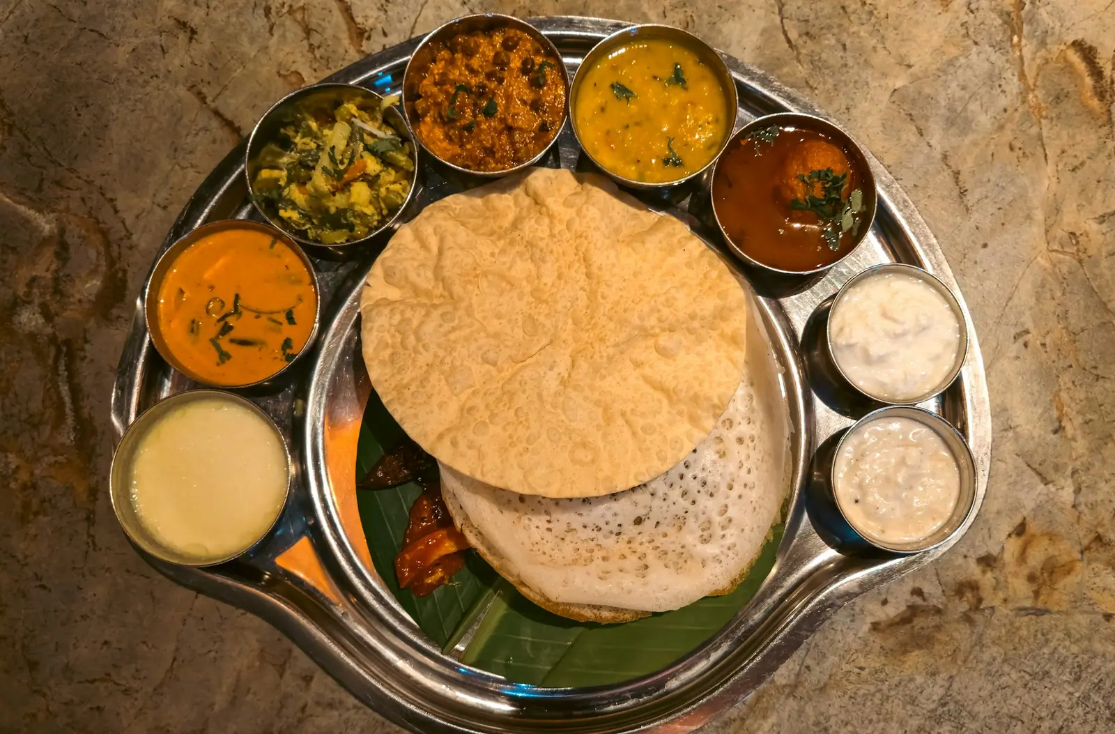 Thali with poori, rice and curries